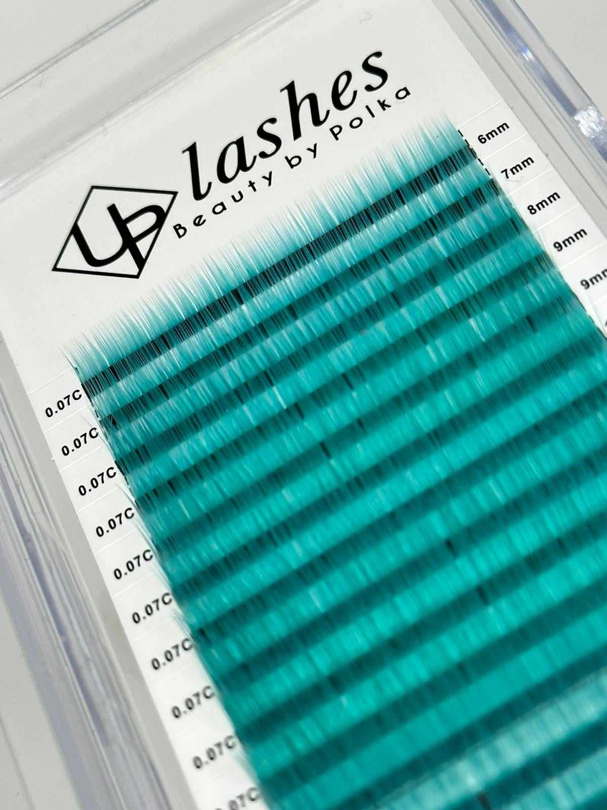 Bright turquoise lash extensions by UPLashes in see-through box
