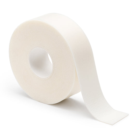 A roll of foam tape used for eyelash application, showing a white tape with a partial unroll, on a white background.