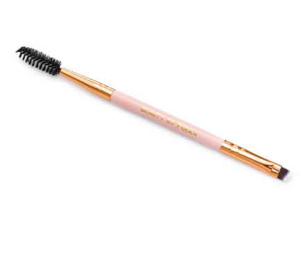 A professional brow brush with a black handle and golden metallic accents, featuring dense bristles and an angled design for applying eyebrow products.