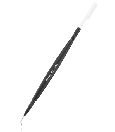 A black eyelash separator with a steel, curved needle on one end and a detachable comb on the other, with the brand name 'Beauty by Polka' printed on the side.