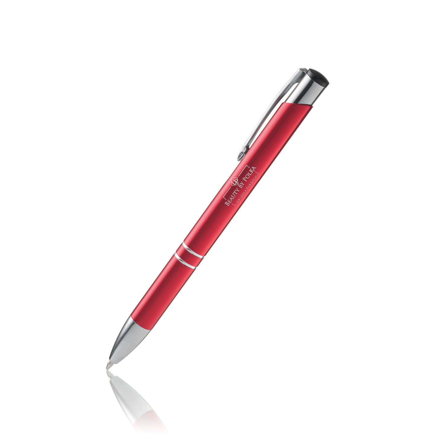 An engraved metal pen with a red lacquered coating, silver accents, and a metal clip. The pen's model name is 'Beauty by Polka'.