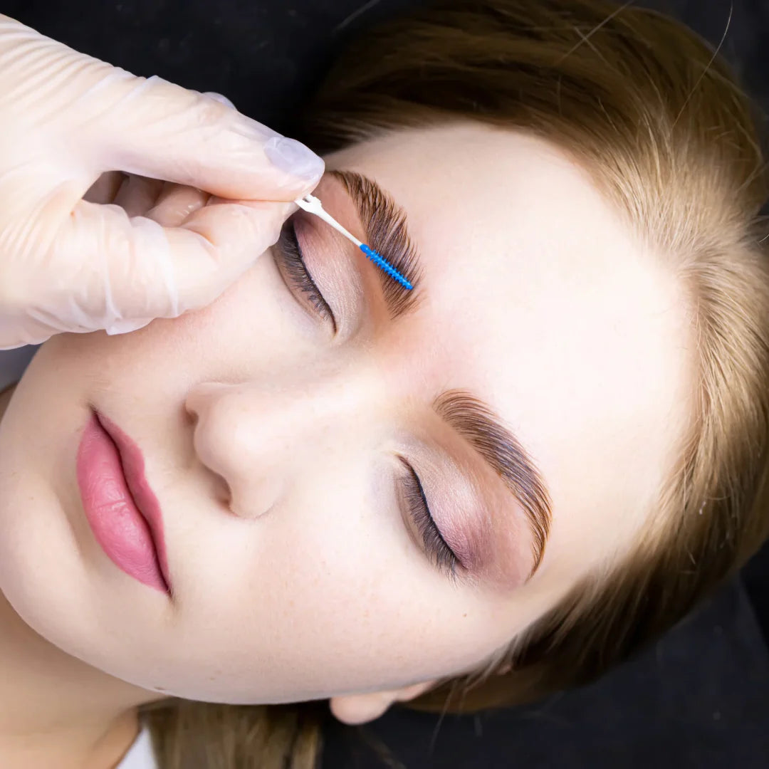 Model receiving powder henna treatment with technical brow drawing